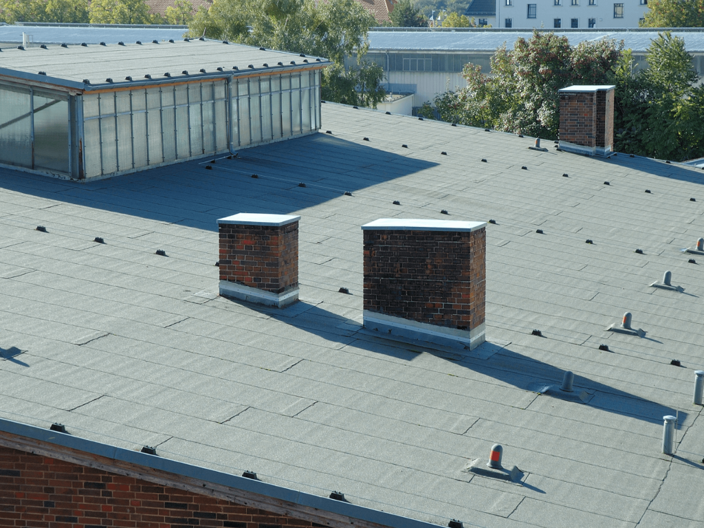 Freshly repaired commercial flat roof with new membrane and sealed seams.